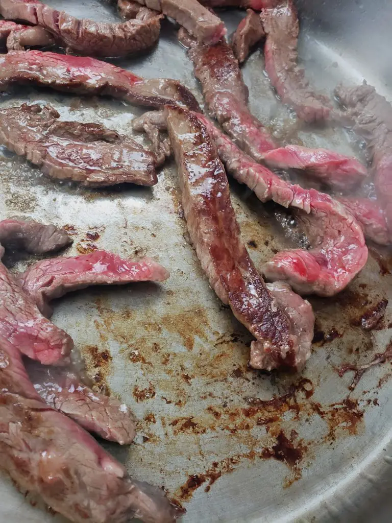 sear flank steak on both sides in large skillet or wok