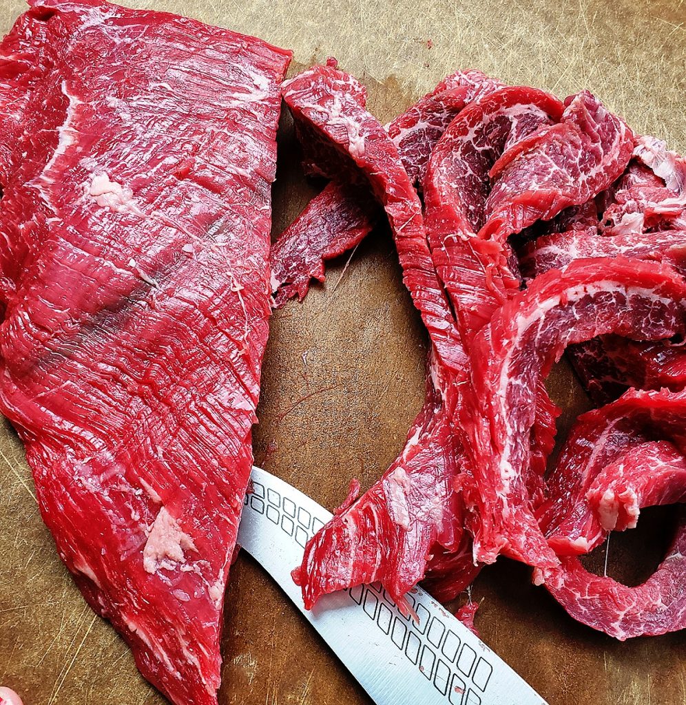 slice flank steak thinly and against the grain