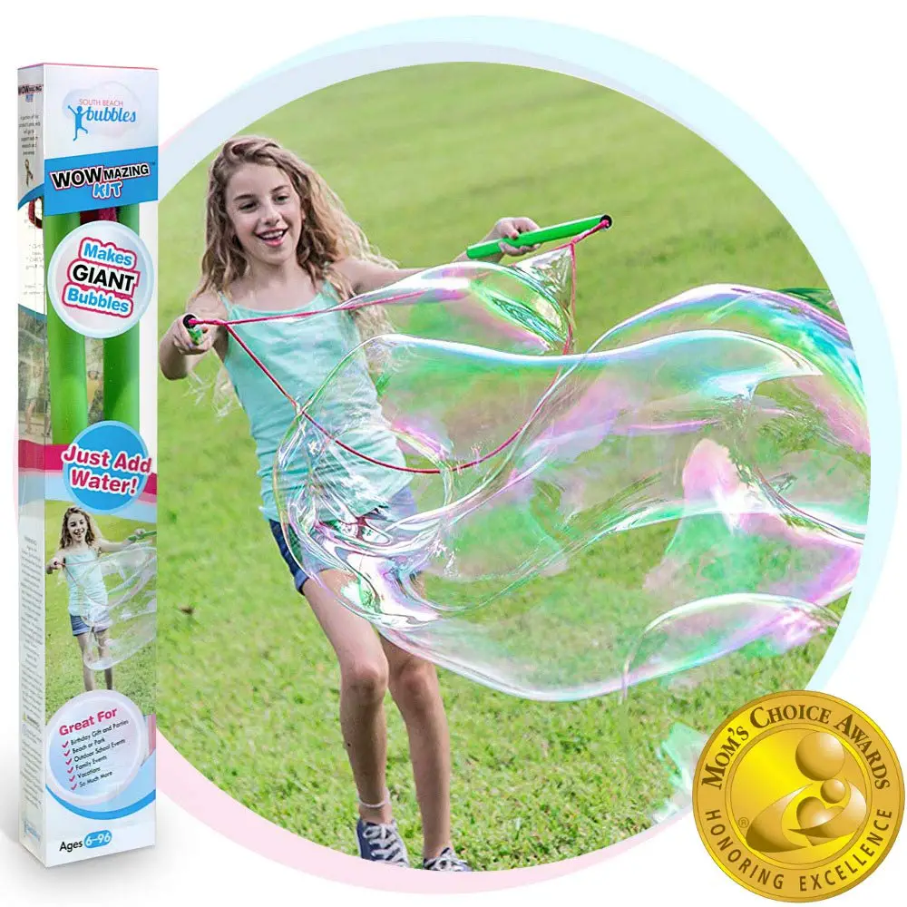 little girl makes very large bubble with wand