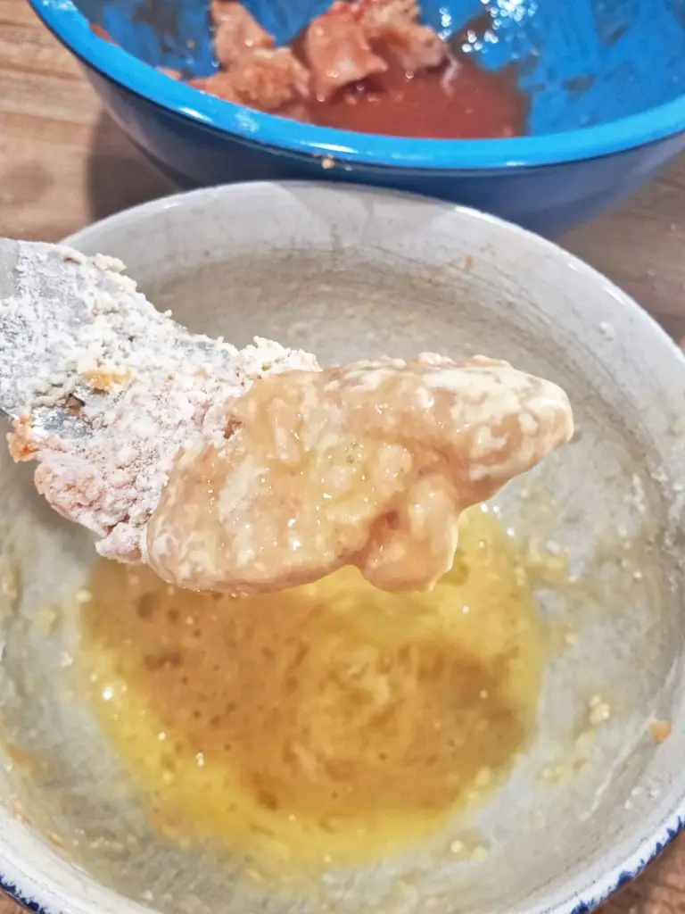 dipping chicken nugget in egg after flour