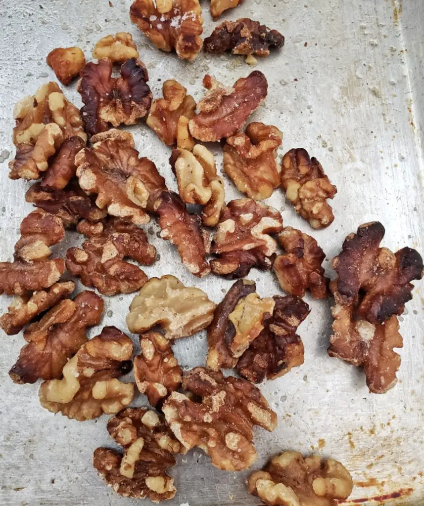 overhead image of roasted whole walnuts on sheet pan