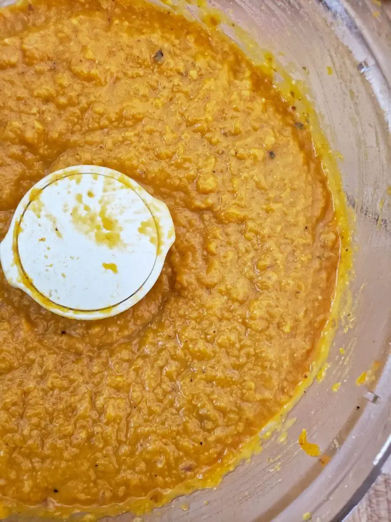 overhead image of pureed butternut squash in the bowl of a food processor