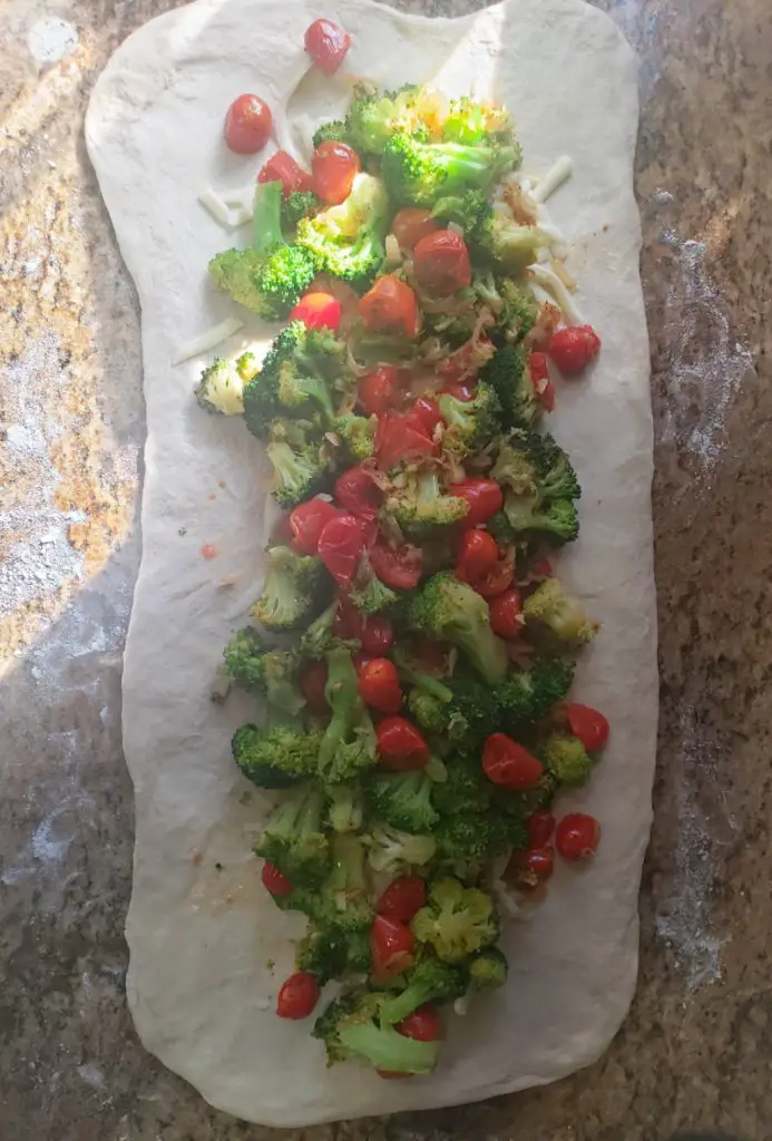vegetable filling on rectangle shaped dough before rolling into stromboli