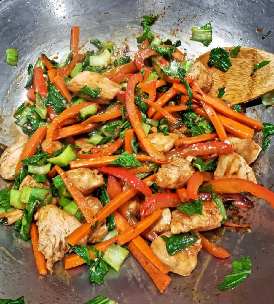 chicken and vegetable stir fry in wok