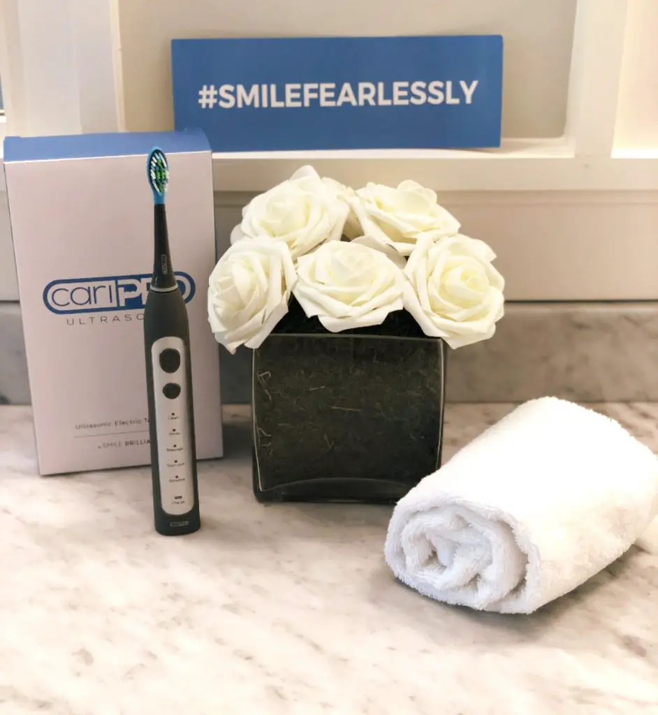 caripro electric toothbrush on bathroom counter