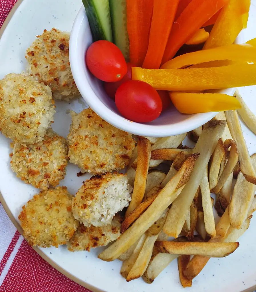homemade chicken nugget dinner with french fries and vegetables