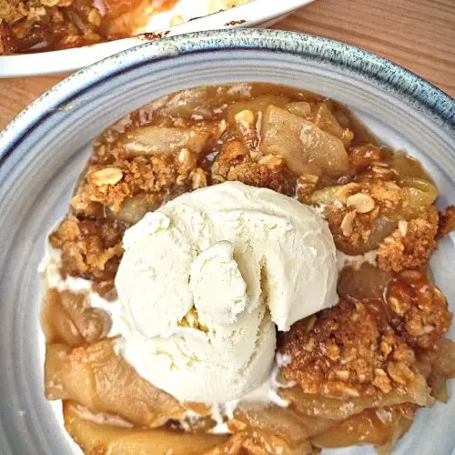 old fashion apple crisp dessert with scoop of vanilla ice cream