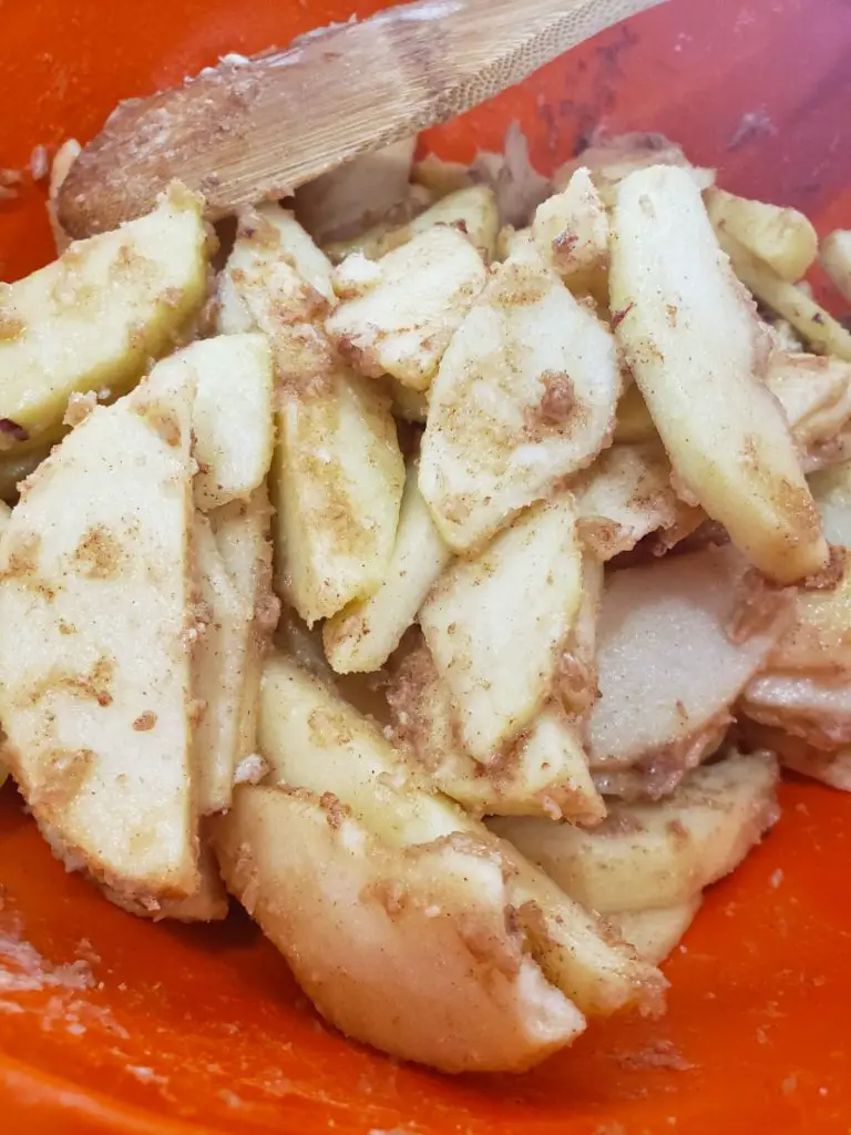 apple slices coated with brown sugar, cinnamon and flour for apple crisp