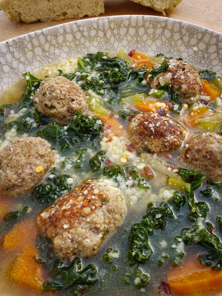 italian wedding soup with meatballs and kale, carrots, celery, chicken broth