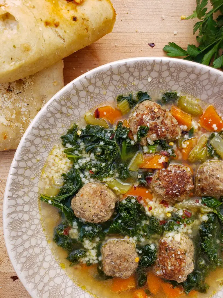 italian wedding soup with focaccia bread and parsley