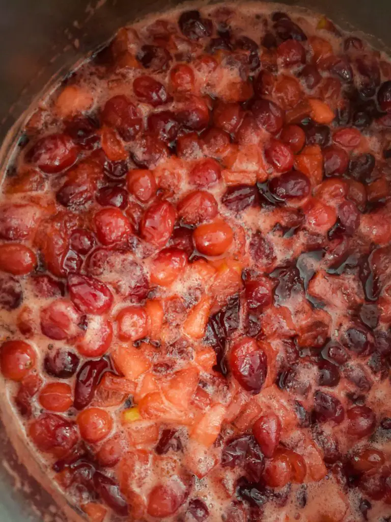 boiling cranberries to make CRANBERRY SAUCE WITH APPLES AND ORANGE ZEST