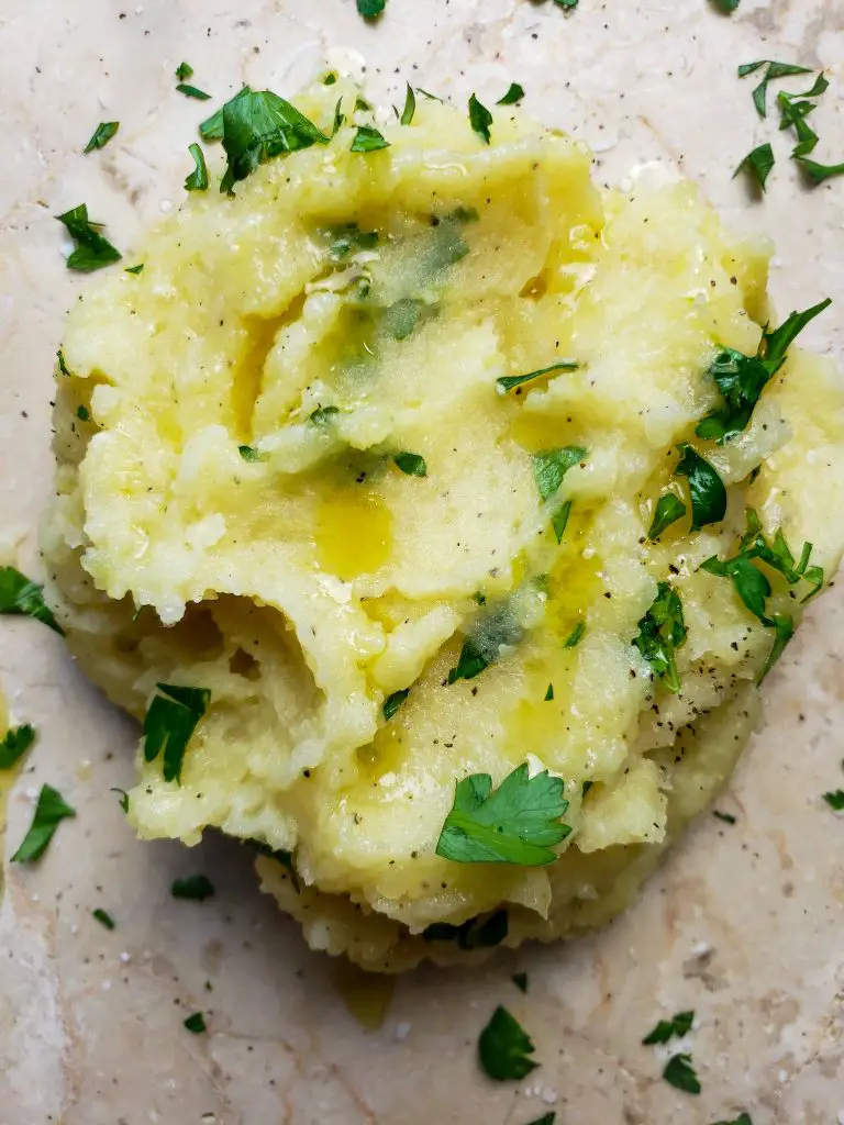 scoop of browned butter mashed potatoes garnished with parsley