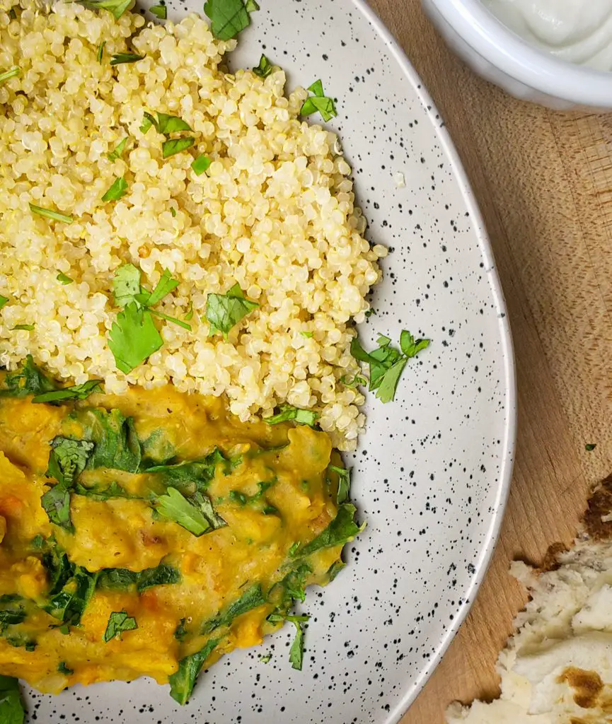 "sweet potato red lentil coconut curry served with a side of quinoa