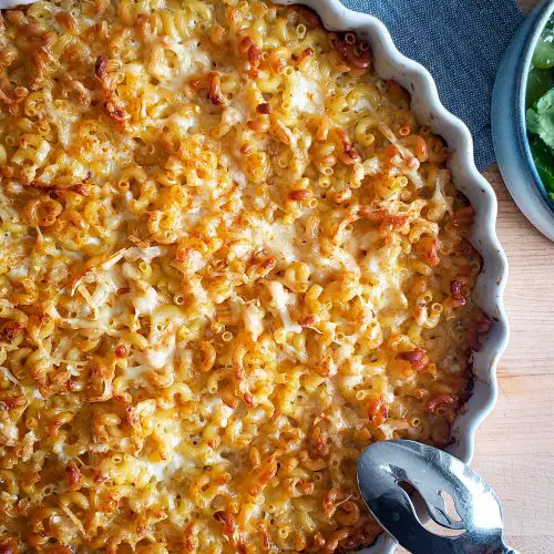overhead image of baked lazy mom mac and cheese next to a side salad