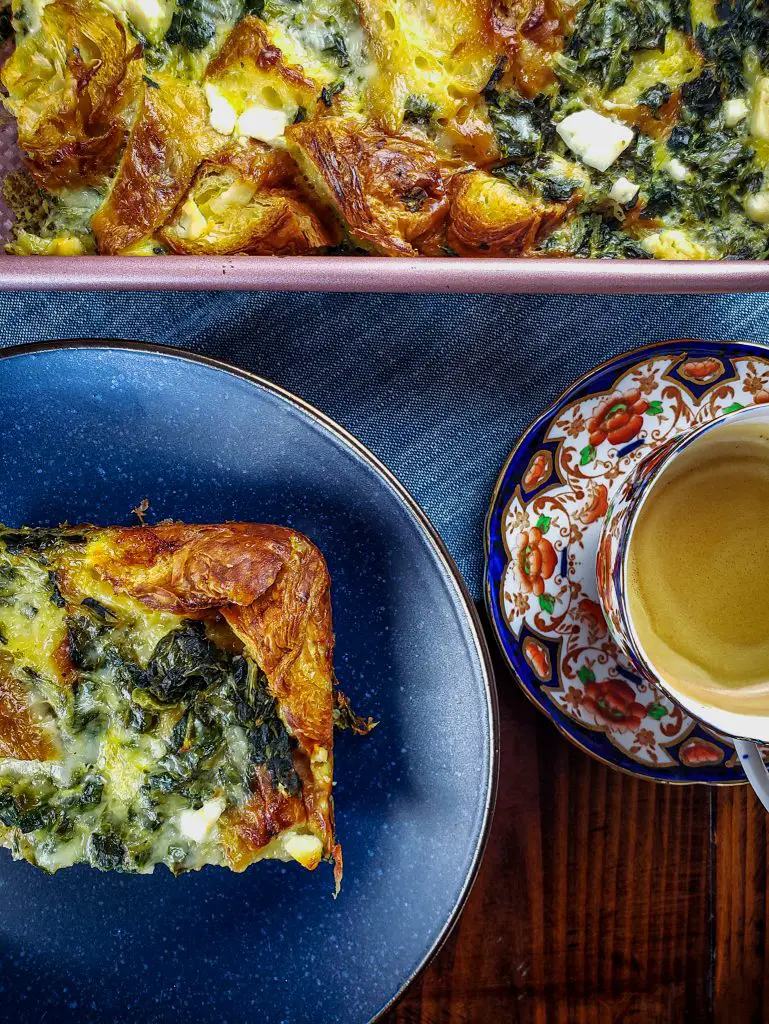 CROISSANT STRATA WITH SPINACH, FETA AND GRUYERE with cup of coffee
