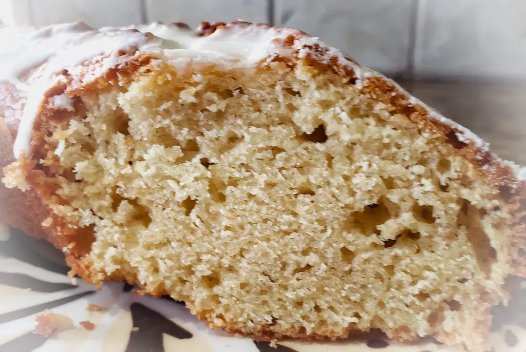 close up image of slice of glazed eggnog bourbon holiday quick bread