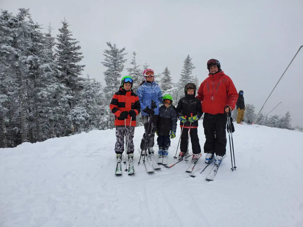 family of five at summit of mountain in sunday rive