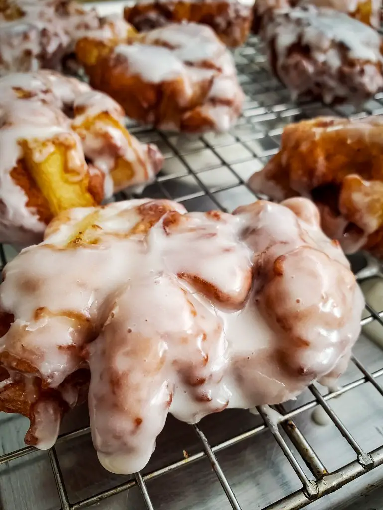 close up side angle of frosted chai spiced apple fritter