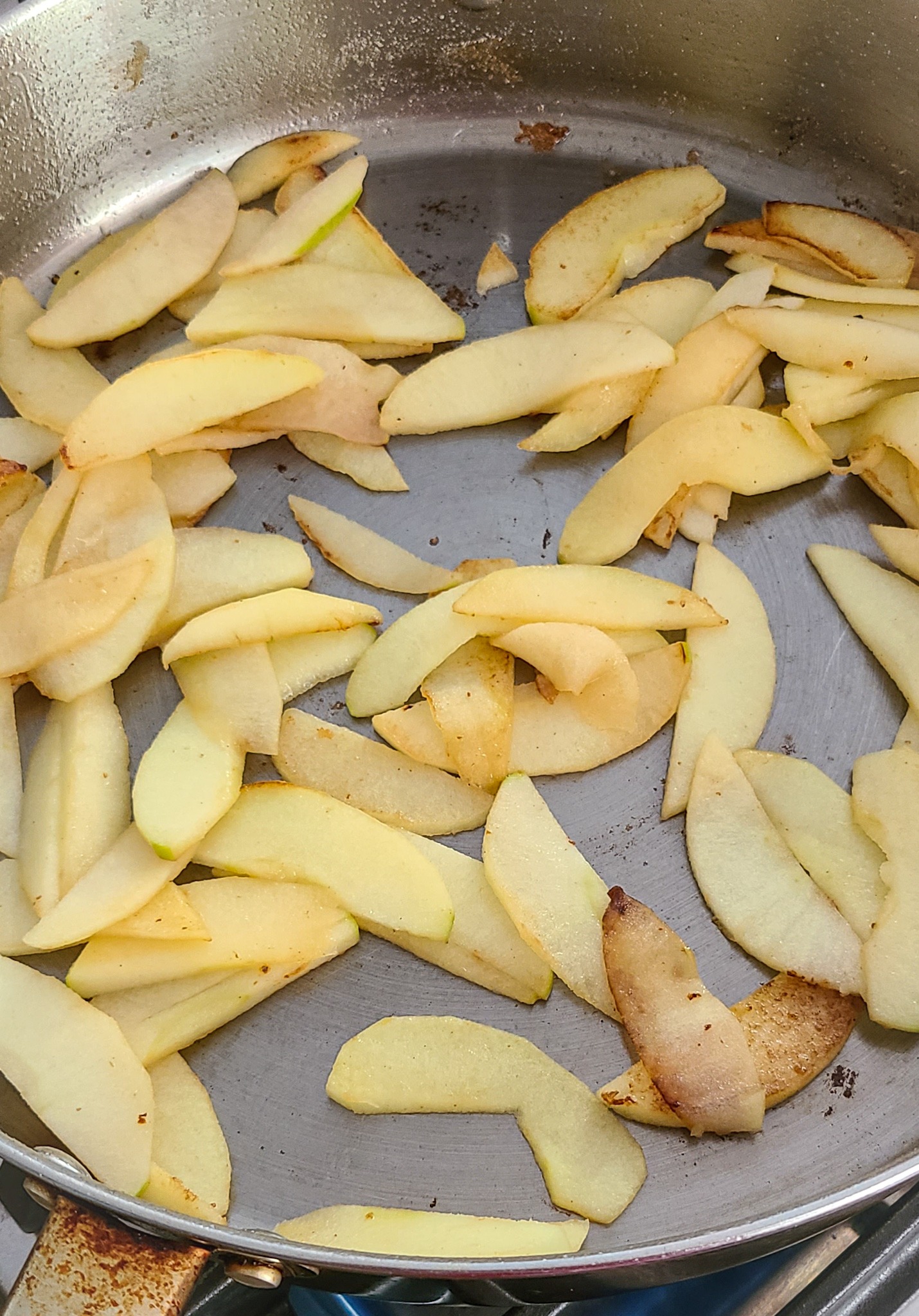 sliced apples searing in pan