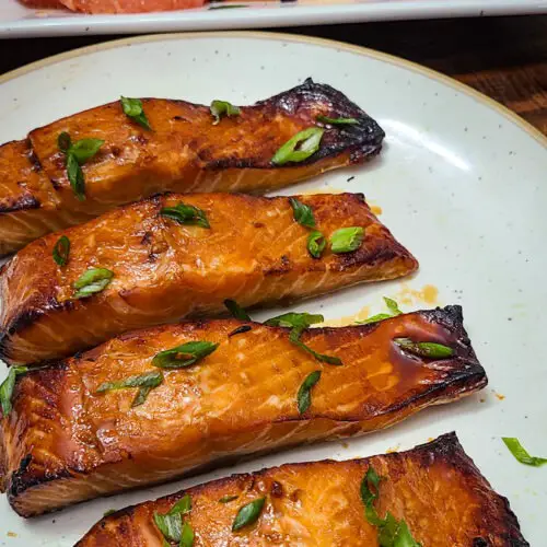 hot honey roasted salmon on plate with citrus pomegranate salad