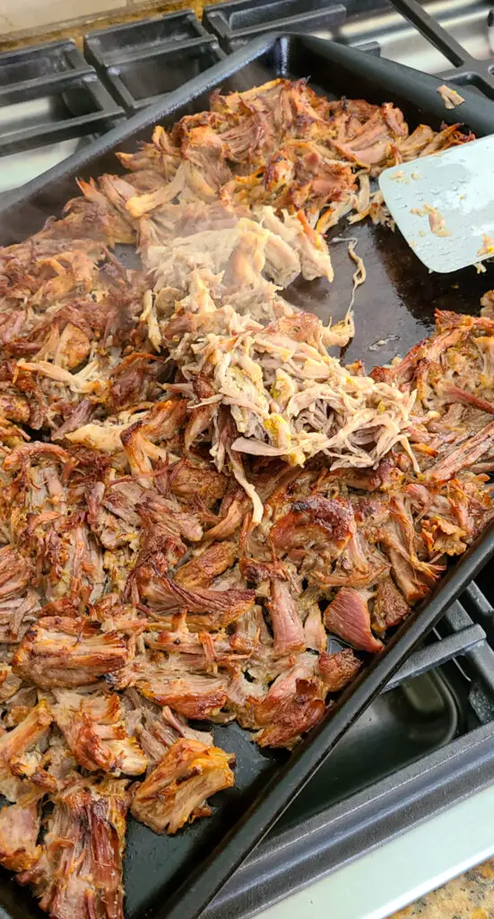 Broil carnitas and flip with spatula and repeat to make crisp