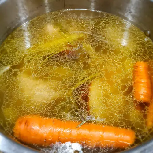 image of chicken stock in instant pot before its been strained of vegetables and meat