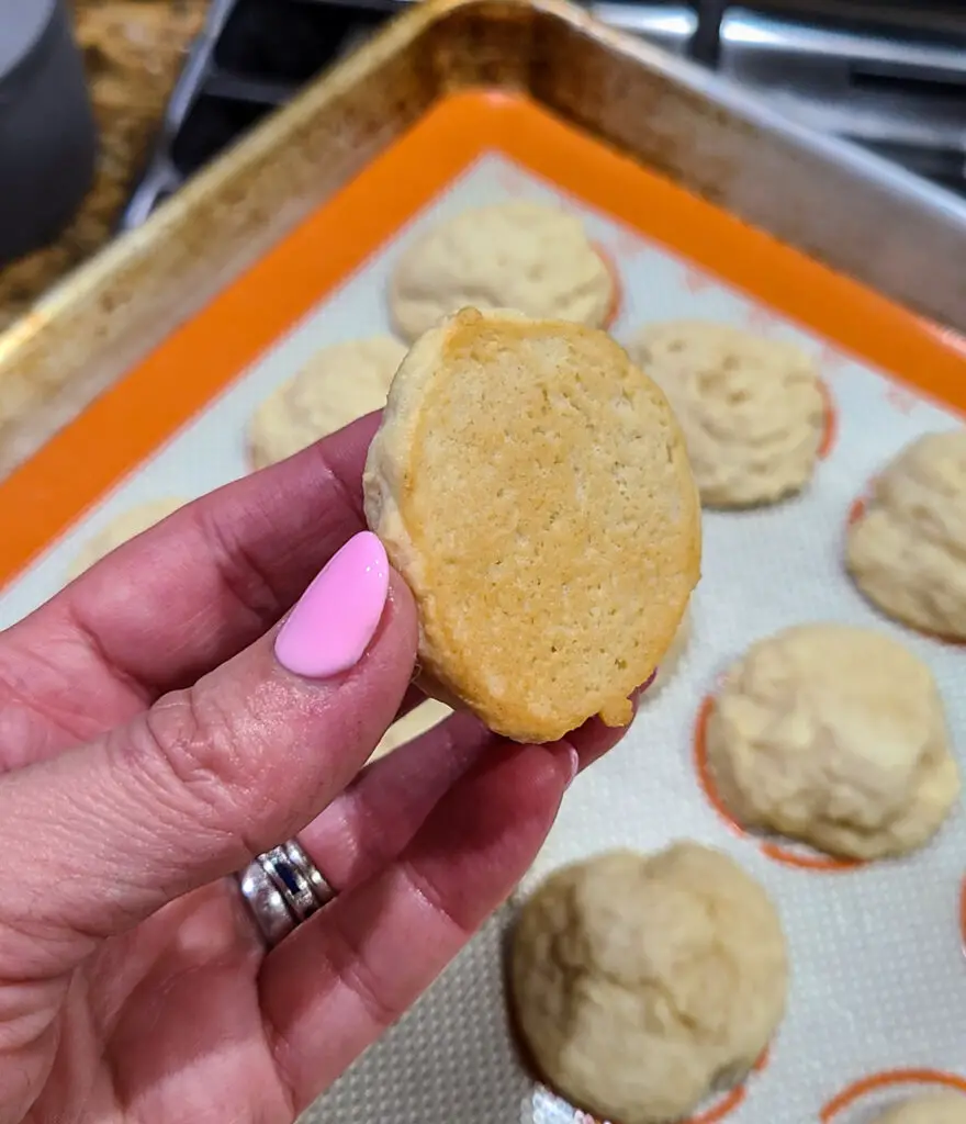 underside of baked lemon ricotta cookie showing the desired color for doneness